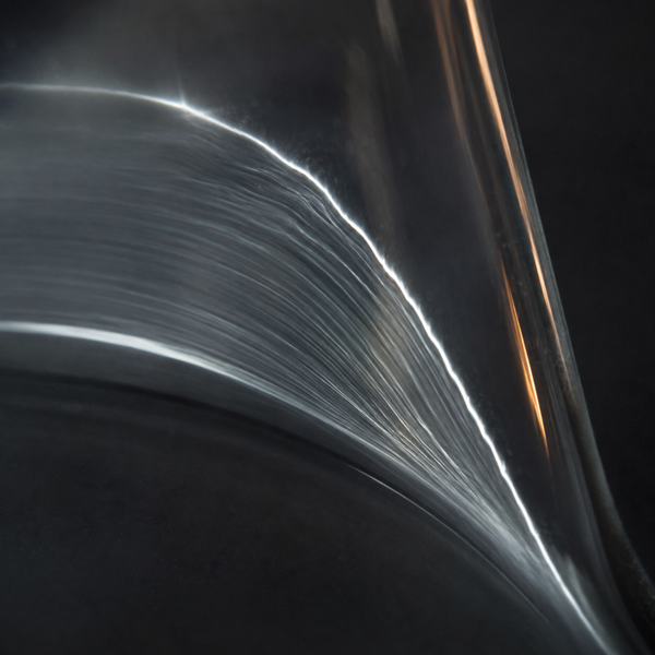 Why the Flask Rotates: Thin Films, Surface Area and Bumping