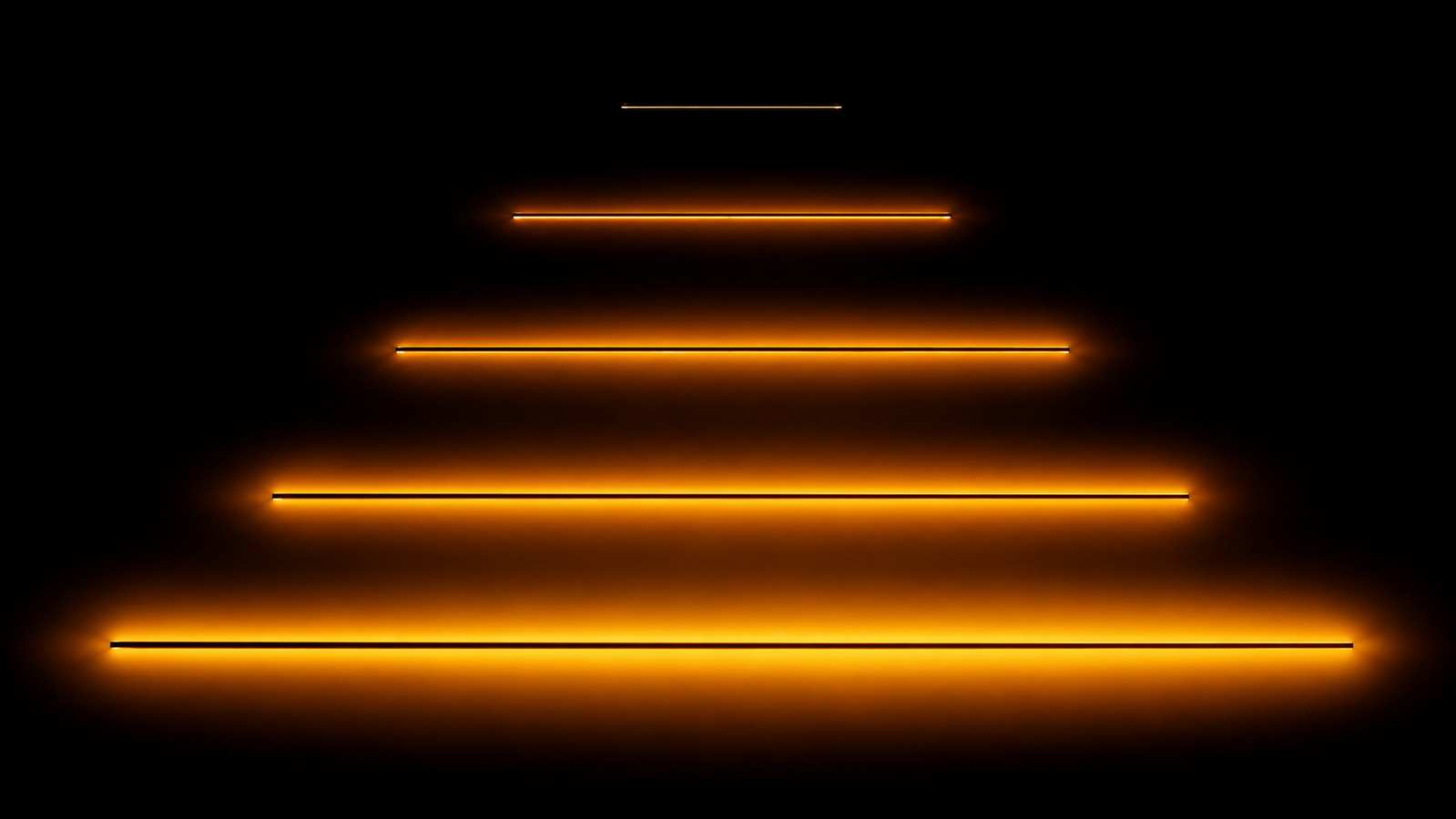 Parallel straight wires of increasing length on a black background, each longer wire wrapped in a progressively wider warm halo of radiated heat