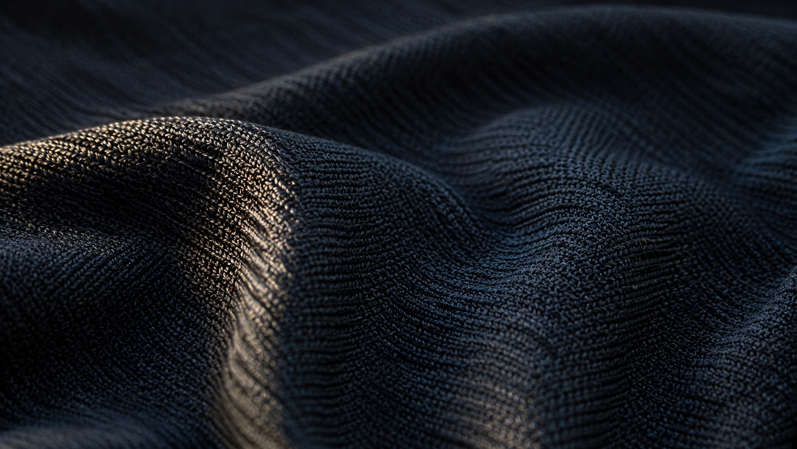 Close-up of a technical knit fabric with a subtle dark graphene coating, illustrating graphene-functionalized textiles